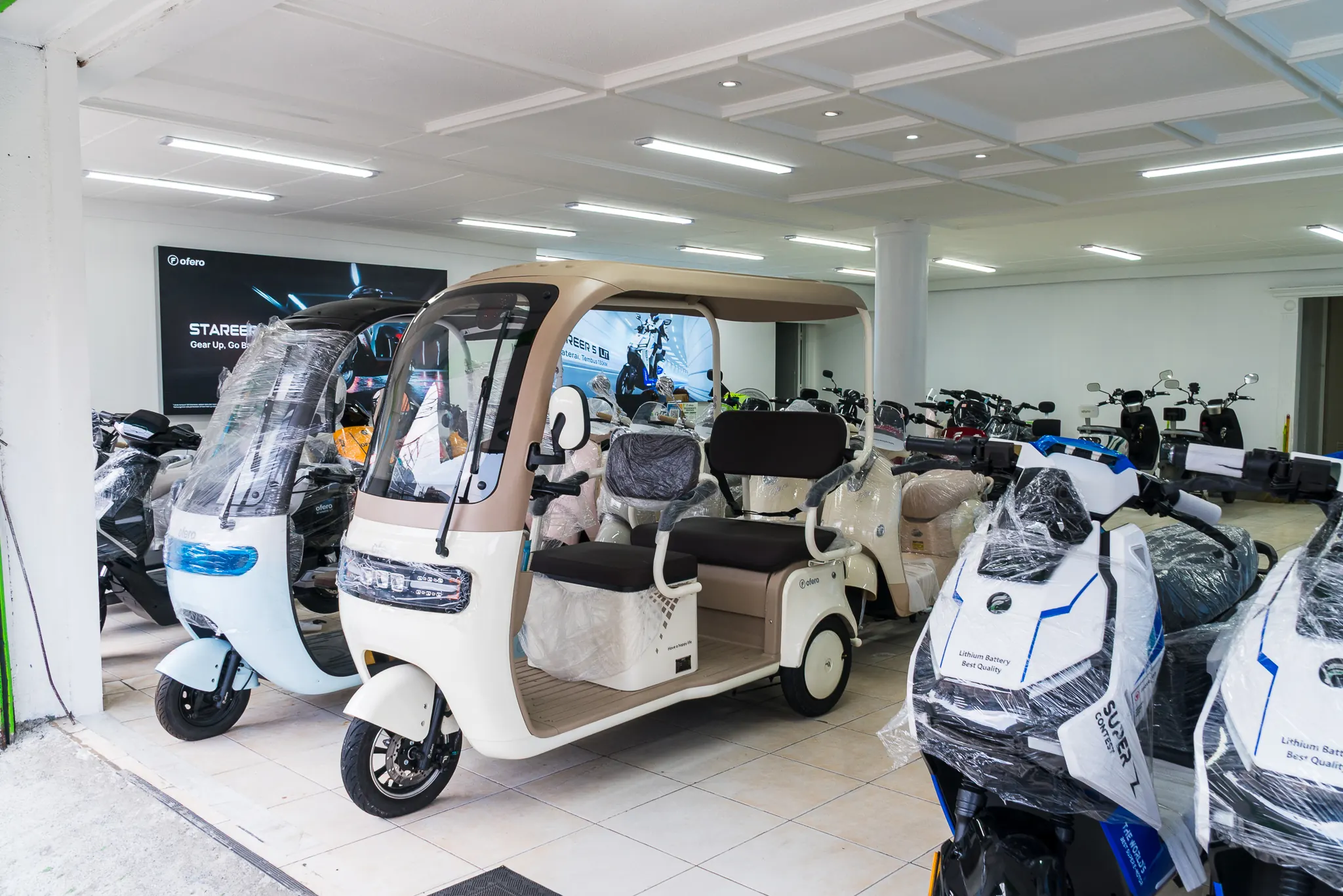 Electric vehicles displayed inside an OFERO showroom; archived reference photograph